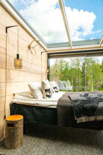 a bedroom with a bed in front of a window at Kuuru Tunturilaakso by Kide Hotel in Syöte