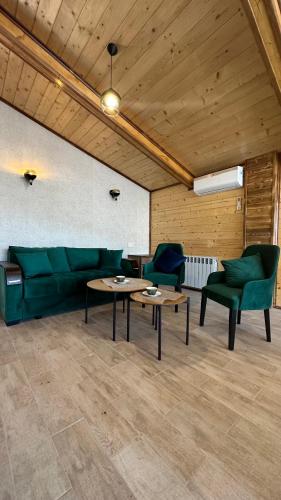 a living room with a couch and two chairs and tables at Harsnadzor Eco Resort in Halidzor
