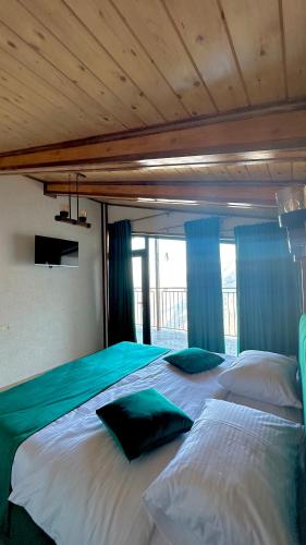 a bedroom with two large beds with blue curtains at Harsnadzor Eco Resort in Halidzor