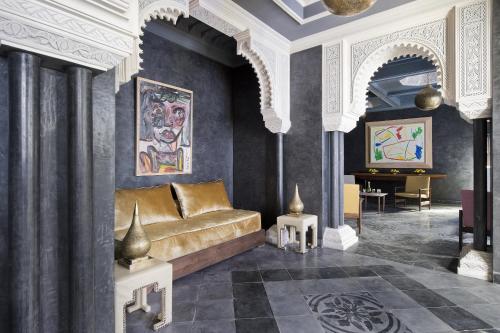 a living room with a couch and a table at Riad Goloboy in Marrakech