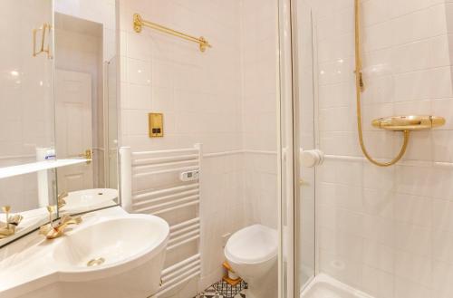 a bathroom with a shower and a toilet and a sink at Shambles Suites in the centre of York, sleeps 16 in York