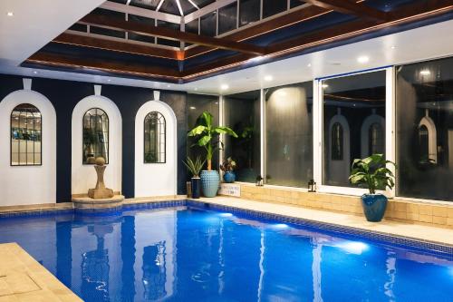 a swimming pool with blue water in a house at The Spa Hotel in Royal Tunbridge Wells
