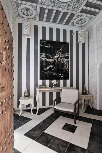 a living room with a table and a chair at Riad Goloboy in Marrakech