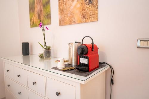 a kitchen counter with a red appliance on top of it at Room Eight - Your Space in the City in Lugano