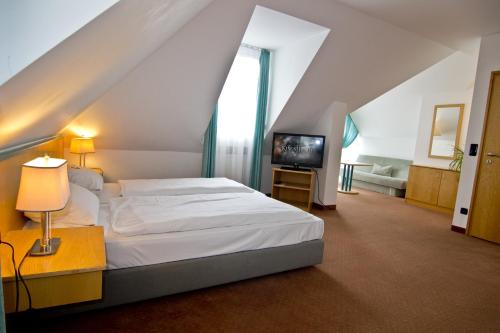 Säng eller sängar i ett rum på Hotel Alpha