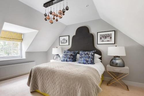 a bedroom with a large bed with blue pillows at The Tempus at Charlton Hall Estate in Alnwick
