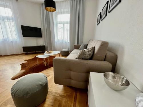 a living room with a couch and a table at FirstClass 2R_Apartment in Leipzig in Leipzig