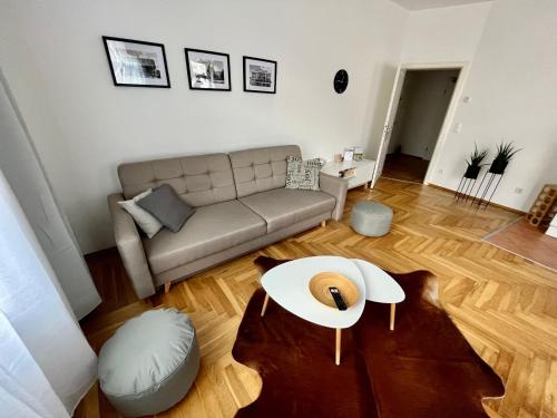 a living room with a couch and a table at FirstClass 2R_Apartment in Leipzig in Leipzig