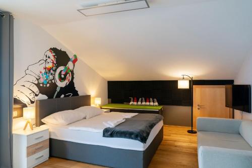 a bedroom with a large bed and a couch at Vive Diem in Haus im Ennstal