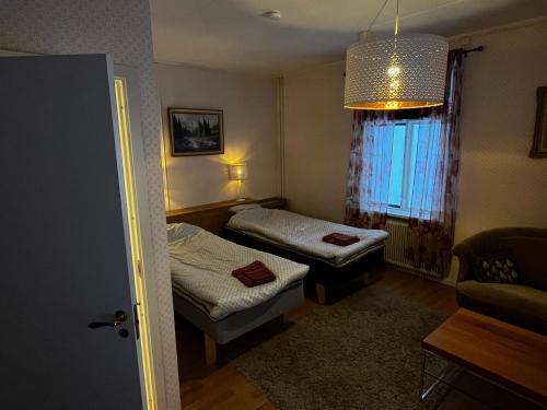 a small room with two beds and a window at Villa Inez in Kopparberg