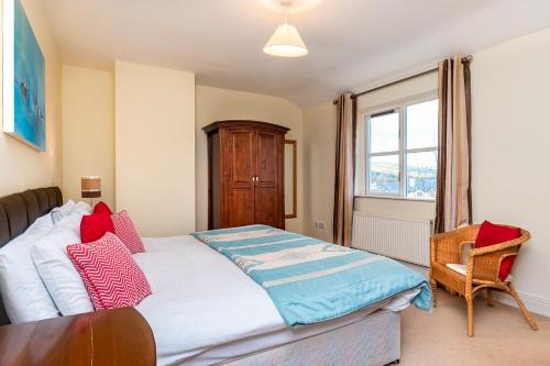 a bedroom with a bed and a chair and a window at Foley's Guesthouse & Self Catering Holiday Homes in Kenmare