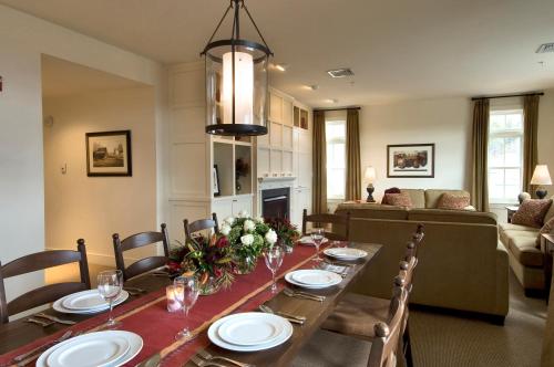 a dining room with a long table with chairs at Clay Brook Hotel at Sugarbush in Warren