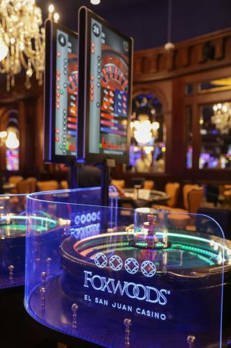 a table with two computer monitors in a casino at Fairmont El San Juan Hotel in San Juan