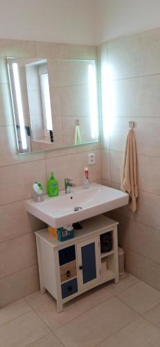 a bathroom with a sink and a mirror at Lipno - Villa Bernard - Lakeside Village in Frymburk