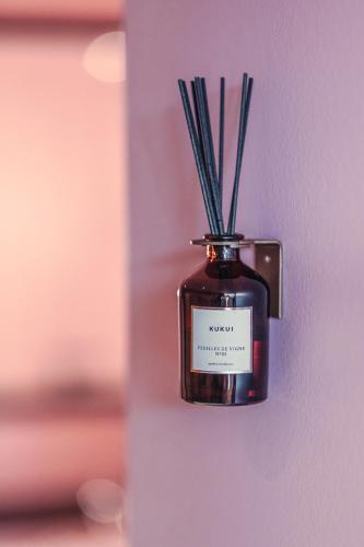 a jar with grasses in it hanging on a wall at Grand Hotel National Luzern in Luzern