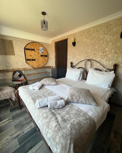 a bedroom with a large bed with towels on it at Harsnadzor Eco Resort in Halidzor