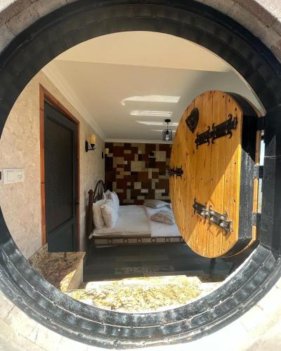 a bedroom with a large wooden door in a room at Harsnadzor Eco Resort in Halidzor