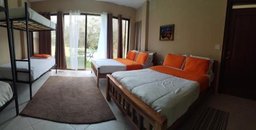 a bedroom with two beds and a bunk bed at Campestre House in Alto Boquete