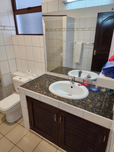 a bathroom with a sink and a toilet at Morning Star Diani in Diani Beach