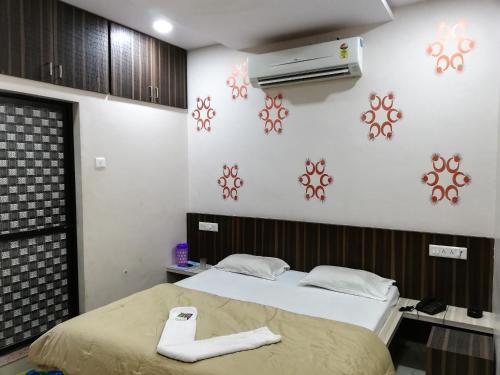 a bedroom with a bed and a air conditioner on the wall at Hotel Shiv Regency in Kukma