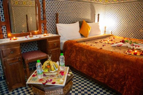 a bedroom with two beds and a vanity and a sink at Riad Baba in Fès