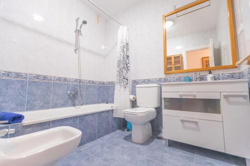 a bathroom with a toilet and a sink and a mirror at Nice 3 Bedroom Villa in El Duque in Adeje