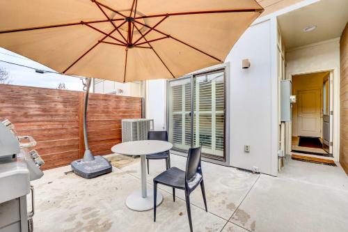 a patio with a table and chairs and an umbrella at Beautiful Townhome - Steps to Downtown Boise! in Boise