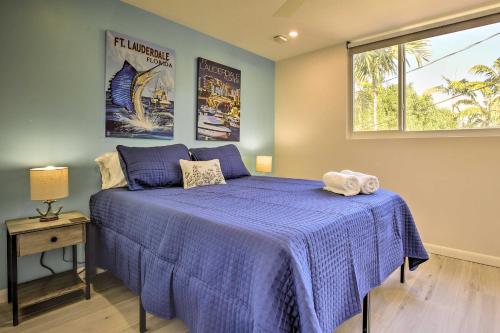 a bedroom with a blue bed and a window at Fort Lauderdale Condo with Patio, Near Canal! in Fort Lauderdale