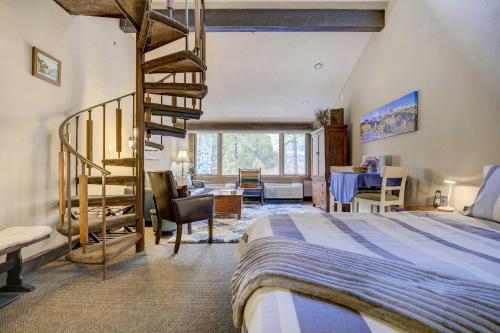 a bedroom with a bed and a spiral staircase at Durango Lofted Studio about 9 Mi to Purgatory Resort! in Durango