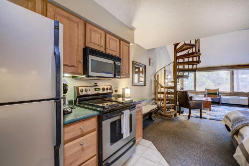 a kitchen with a refrigerator and a stove top oven at Durango Lofted Studio about 9 Mi to Purgatory Resort! in Durango