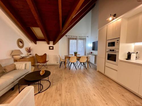 a living room with a couch and a table at BPIRINEOS-Ibón Blanco in Benasque