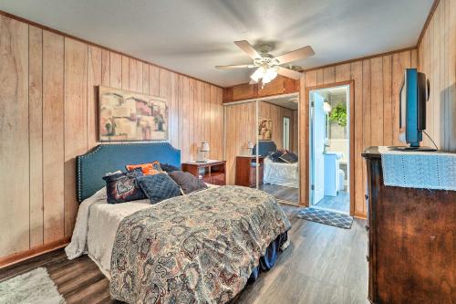 a bedroom with a bed and a ceiling fan at Jacksonville Getaway about 4 Mi to Downtown! in Jacksonville