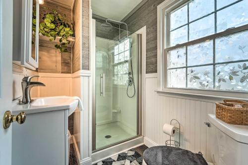a bathroom with a shower and a sink and a window at Jacksonville Getaway about 4 Mi to Downtown! in Jacksonville