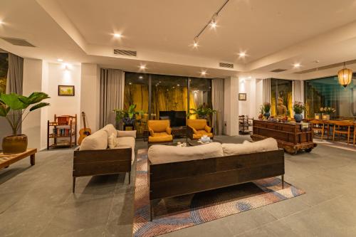 a living room with two couches and a table at Akala Villa Hoi An in Hoi An