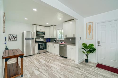 a kitchen with white cabinets and a wooden floor at Singer Island Stunner 2 BR in West Palm Beach