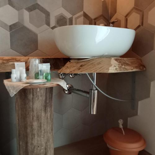 a bathroom with a sink on a wooden table at SANTINO'S HOUSE in Peveragno