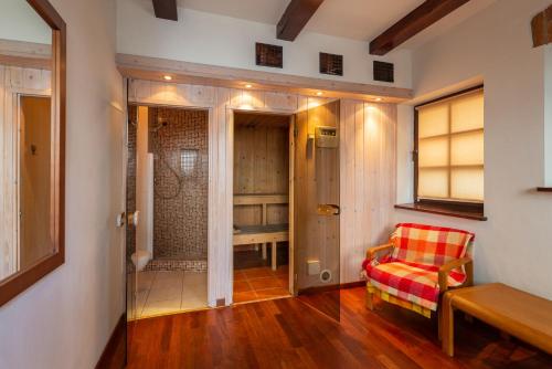 a living room with a red chair and a closet at Hotel Beskid in Milówka