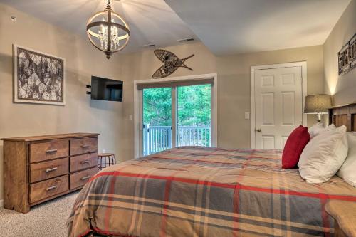 a bedroom with a bed and a dresser and a window at Relaxing Lincoln Condo with Fireplace and Shuttle in Lincoln
