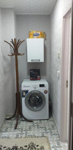 a washer and dryer in a corner of a room at MamaiaApart in Lupeni