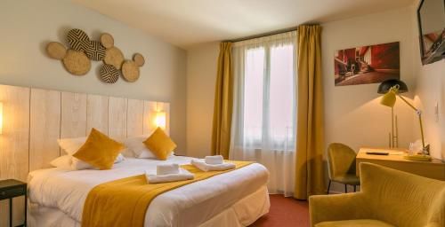 a hotel room with two beds and a chair at Le Central Boutique Hôtel in Beaune