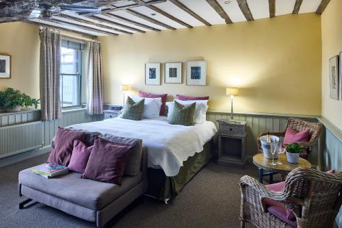 a bedroom with a large bed and a couch at The Mistley Thorn in Mistley