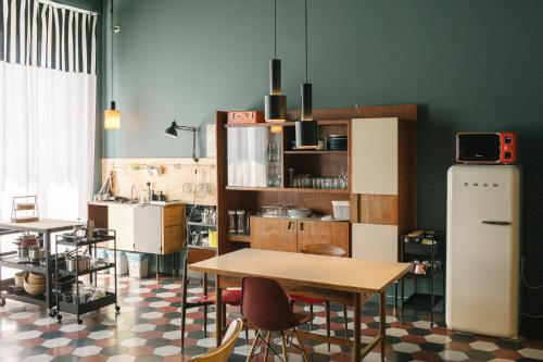 a kitchen with a table and chairs and a refrigerator at casaBASE in Milan