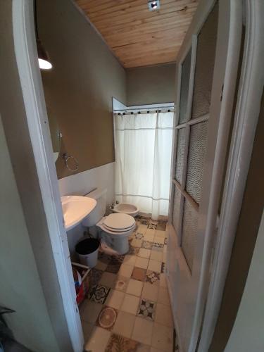 a bathroom with a toilet and a sink at Casa quinta 281 in La Plata