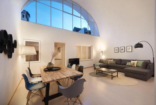 a living room with a table and a couch at Argentieri City Loft in Bolzano