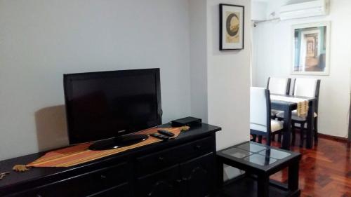 a living room with a flat screen tv on a dresser at DEPARTAMENTO EN NUEVA CORDOBA - Bvd Chacabuco in Cordoba