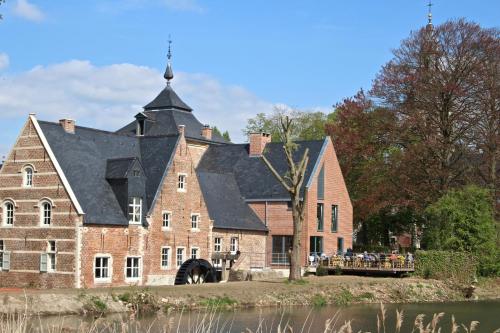 a large red brick building with a black roof at Studio's Park - Heverlee in Leuven
