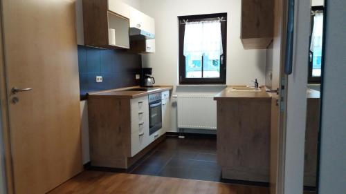 a small kitchen with a sink and a window at Am Wiesengrund in Lebus