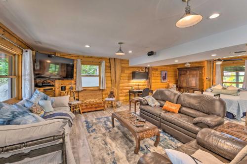 a living room with a couch and a table at Cozy Wisconsin Studio, 11 Mi to Lake Geneva! in Burlington