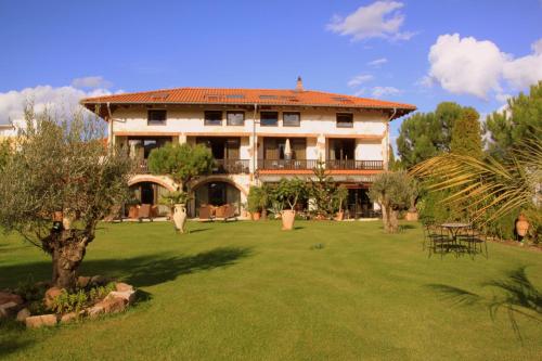 a large house with a lawn in front of it at Hazienda Apartmenthotel in Gernsbach