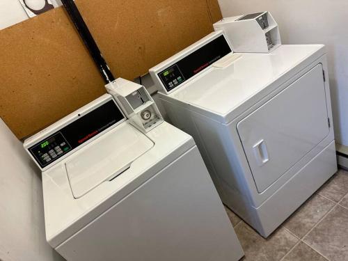 a small white refrigerator next to a cardboard box at Lovely 2 bedroom condo, 2 minute walk fr downtown in Invermere